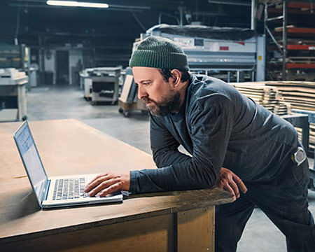 Upfitter looking through technical specs on his laptop computer.